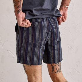 fit model showing the back pockets on The Apres Short in Indigo Stripe