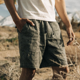 fit model standing with his hand in the front pocket of The Apres Trail Short in Static Camo Double Cloth