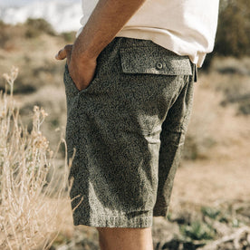 fit model showing the back flap pocket on The Apres Trail Short in Static Camo Double Cloth