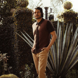 fit model in a garden in The Button Down Polo in Morita Seed Stitch