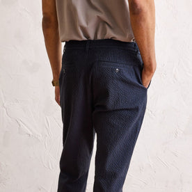 fit model showing the back of The Easy Pant in Heather Navy Seersucker
