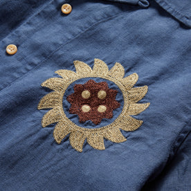 material shot of the sun embroidery on the left chest of The Embroidered Hawthorne in Sea Glass Hemp