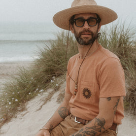 fit model on the beach in The Embroidered Heavy Bag Tee in Dried Acorn Aubade