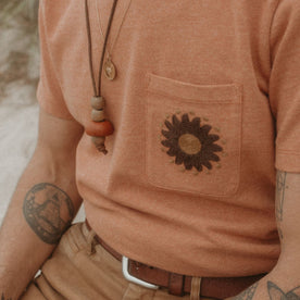 fit model showing the embroidery on the chest pocket of The Embroidered Heavy Bag Tee in Dried Acorn Aubade