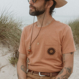 fit model sitting in The Embroidered Heavy Bag Tee in Dried Acorn Aubade