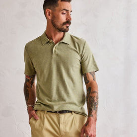 fit model standing in The Herringbone Polo in Heather Sage