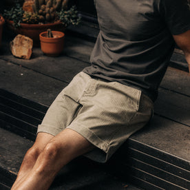 fit model sitting on a deck in The Matlow Short in Arid Eucalyptus Washed Herringbone