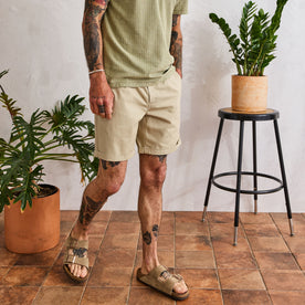 fit model walking next to plants in The Matlow Short in Dune Washed Herringbone