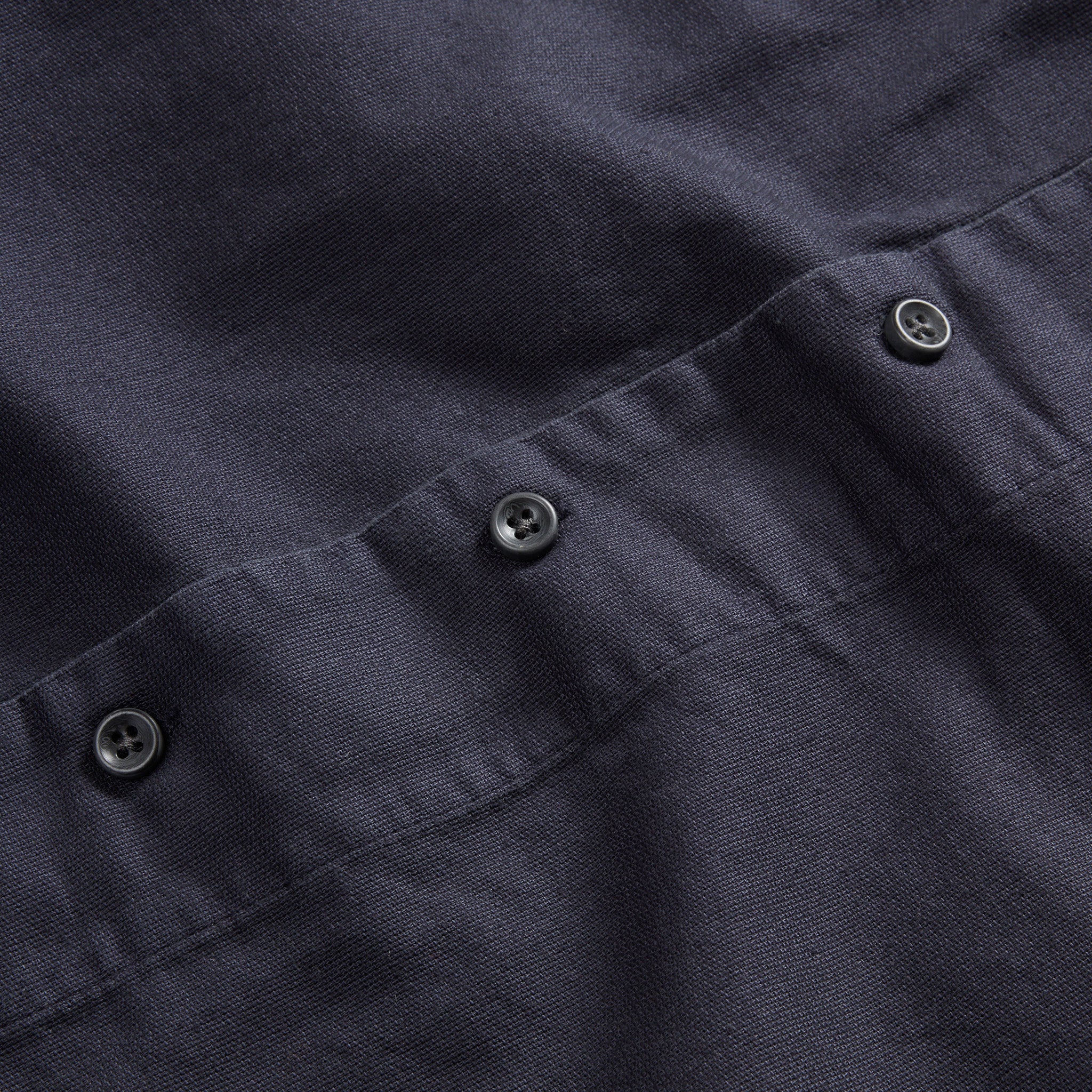 material shot of the dark buttons on The Short Sleeve Hawthorne in Marine, Wovens by Taylor Stitch