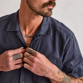 fit model buttoning up The Short Sleeve Hawthorne in Marine