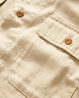 material shot of the buttons and pocket on The Short Sleeve Officer Shirt in Dune Double Cloth, Wovens by Taylor Stitch
