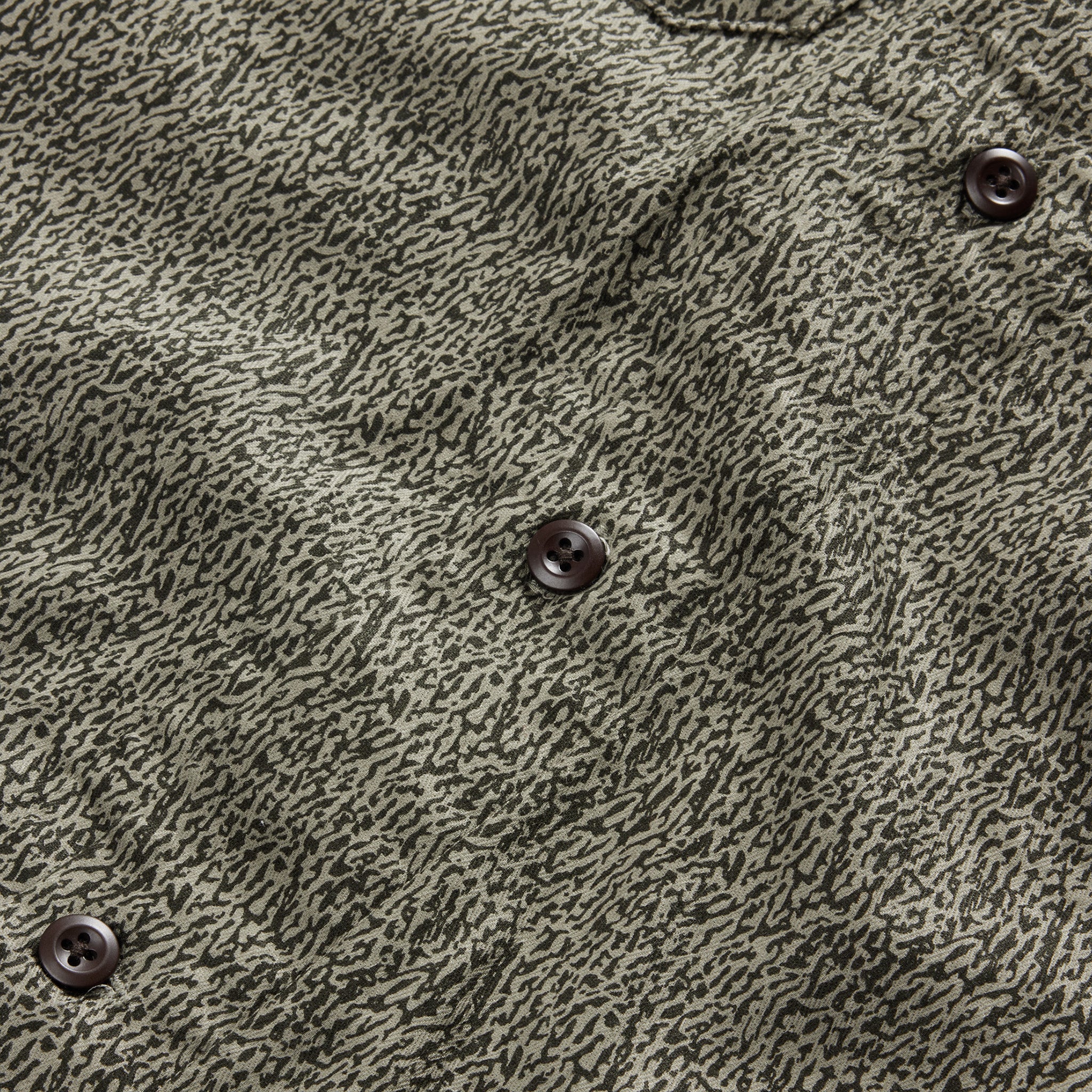 material shot of the buttons on The Short Sleeve Officer Shirt in Static Camo Double Cloth, Wovens by Taylor Stitch