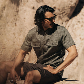 fit model sitting in The Short Sleeve Officer Shirt in Static Camo Double Cloth