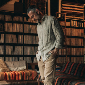 fit model standing by a vinyl shelf in The Jack in Arid Eucalyptus Linen