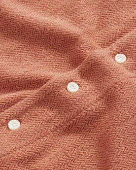 material shot of the natural buttons on The Latigo Shirt in Copper Herringbone, Knits by Taylor Stitch