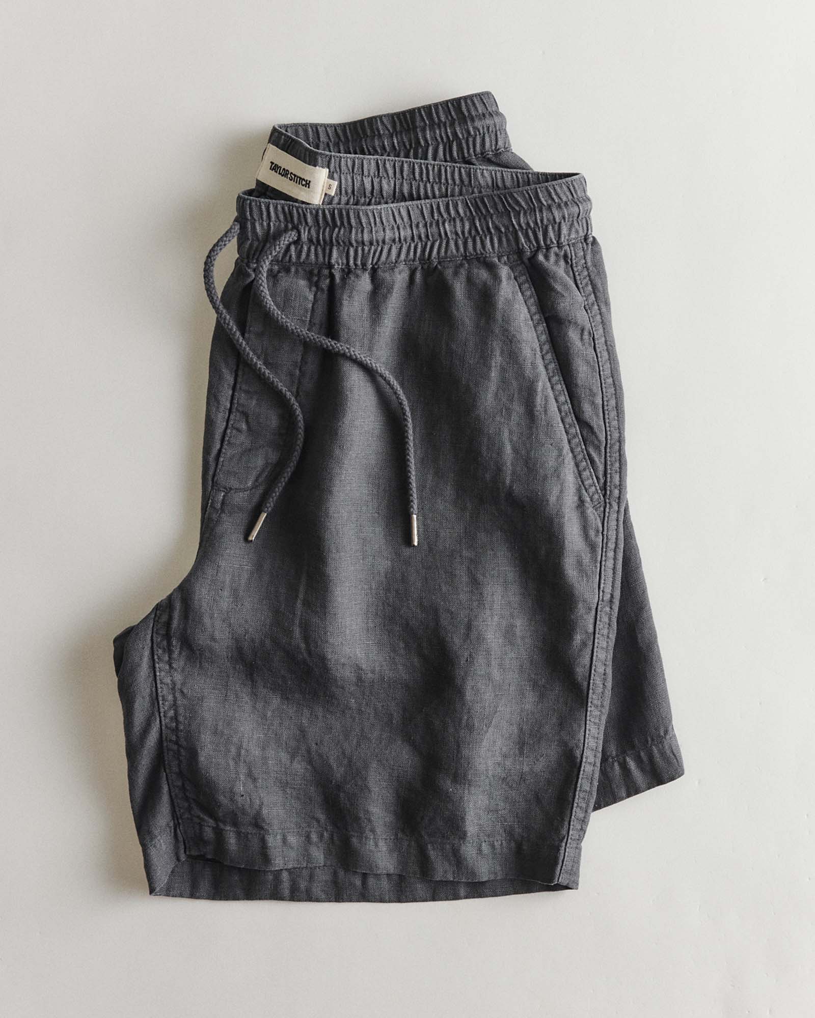 folded flatlay of The Apres Short in Faded Black Hemp, Bottoms by Taylor Stitch