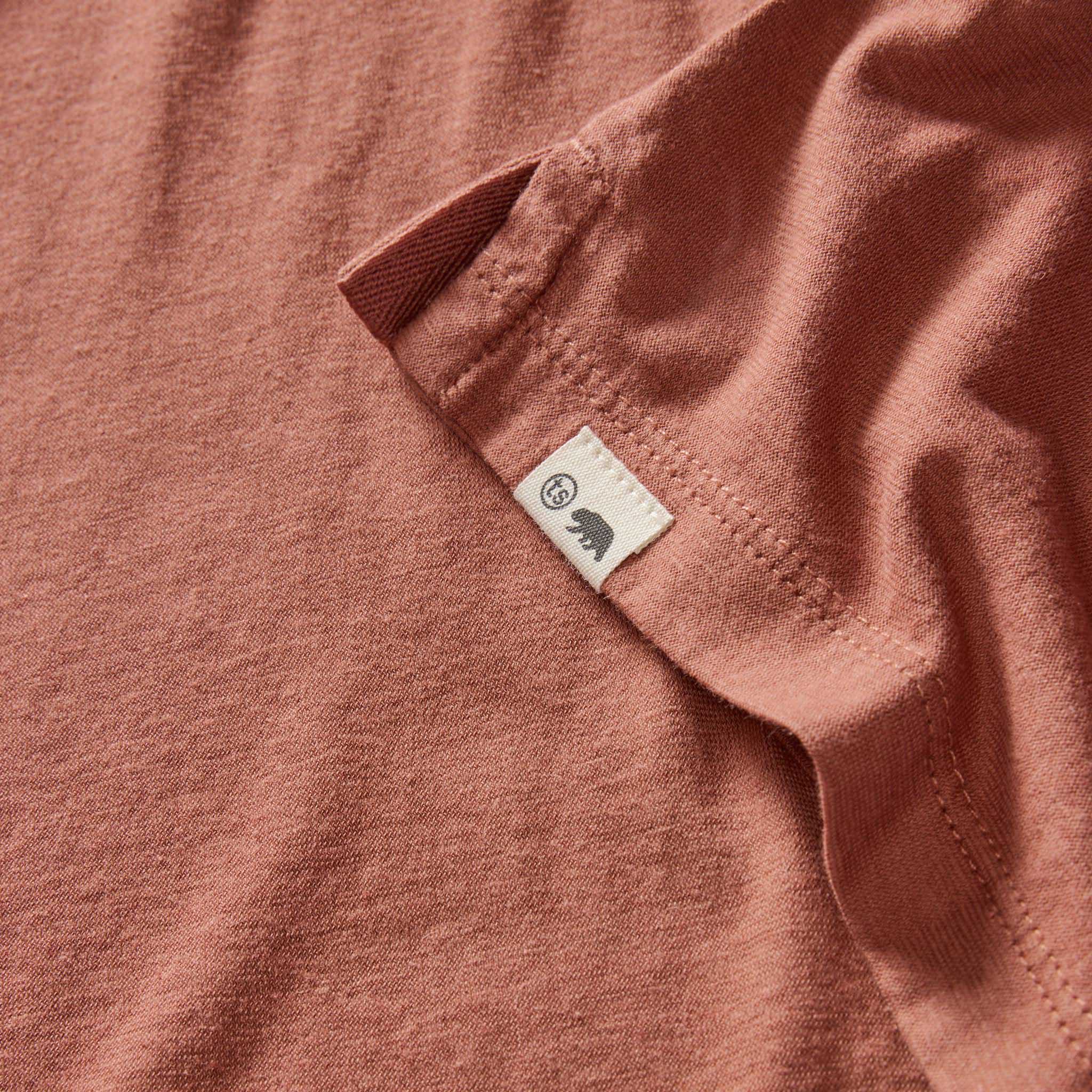 material shot of the logo on The Cotton Hemp Polo in Fired Clay, Knits by Taylor Stitch