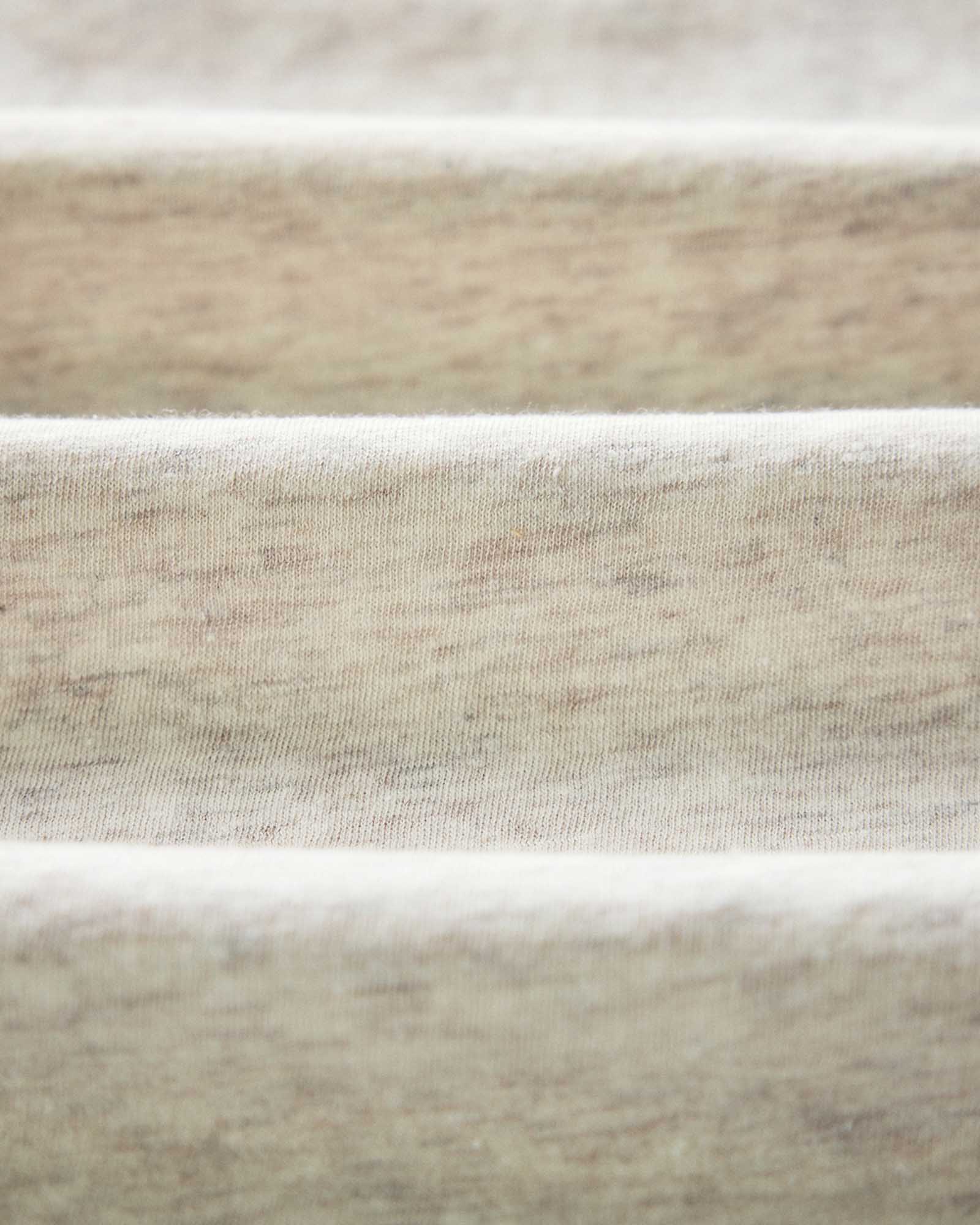 material shot of the logo on The Cotton Hemp Polo in Heather Oat, Knits by Taylor Stitch