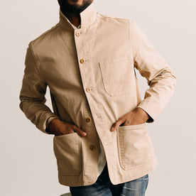 fit model with his hands in his pockets wearing The Ojai Jacket in Organic Light Khaki Foundation Twill