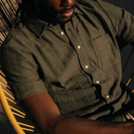 fit model sitting wearing The Short Sleeve California in Heather Olive Pointelle Stripe