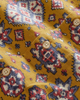 material shot of the buttons on The Short Sleeve Davis Shirt in Tarnished Gold Print, Wovens by Taylor Stitch