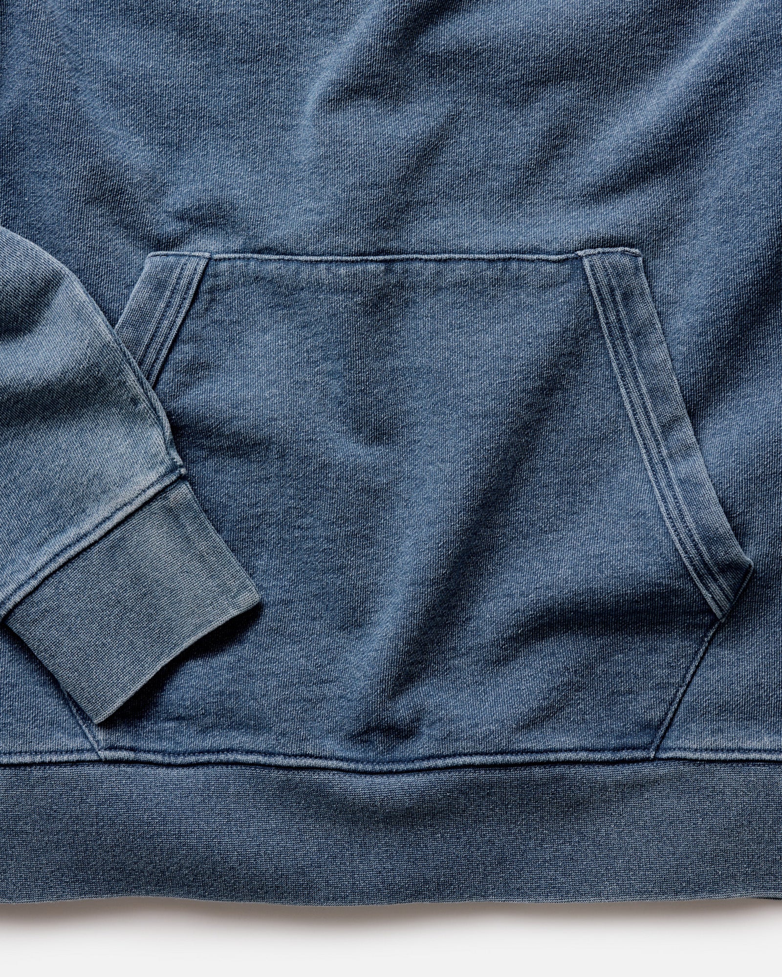 material shot of the bottom on The Apres Hoodie in Washed Indigo Terry, Knits by Taylor Stitch