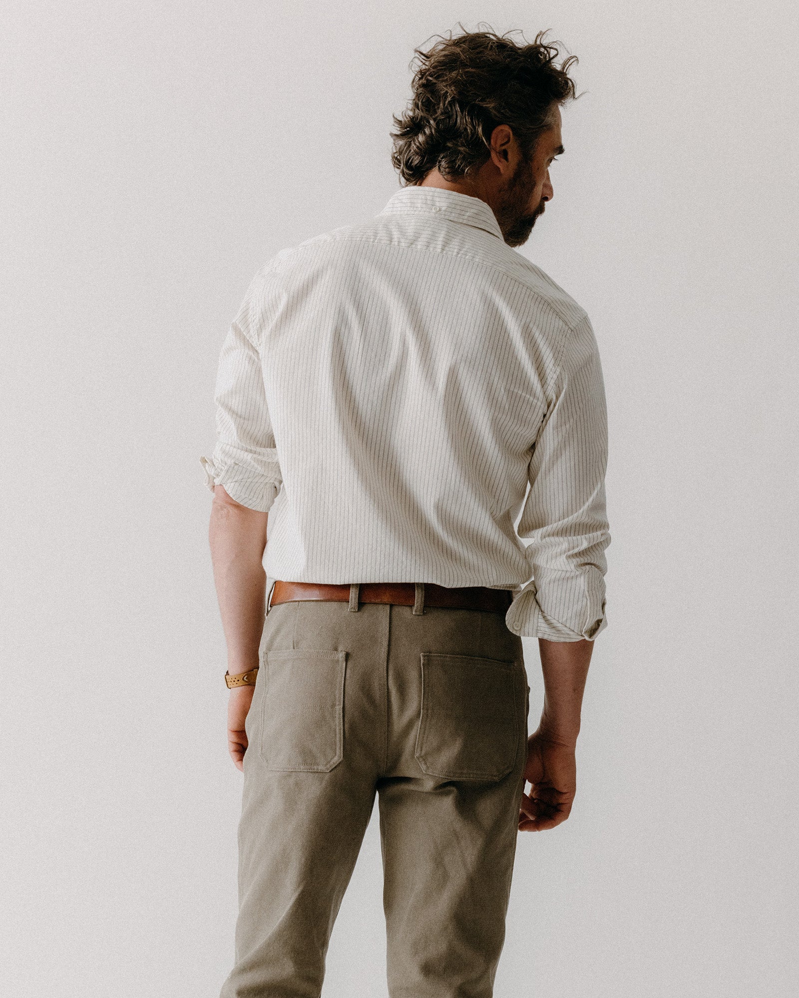 fit model showing off the back of The Camp Pant in Stone Chipped Canvas, Bottoms by Taylor Stitch