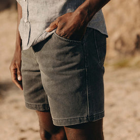 fit model with his hand in his pocket wearing The Camp Short in Coal Chipped Canvas