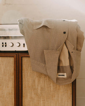 editorial image of The Conrad Shirt in Black Coffee Stripe on a shelf, Wovens by Taylor Stitch