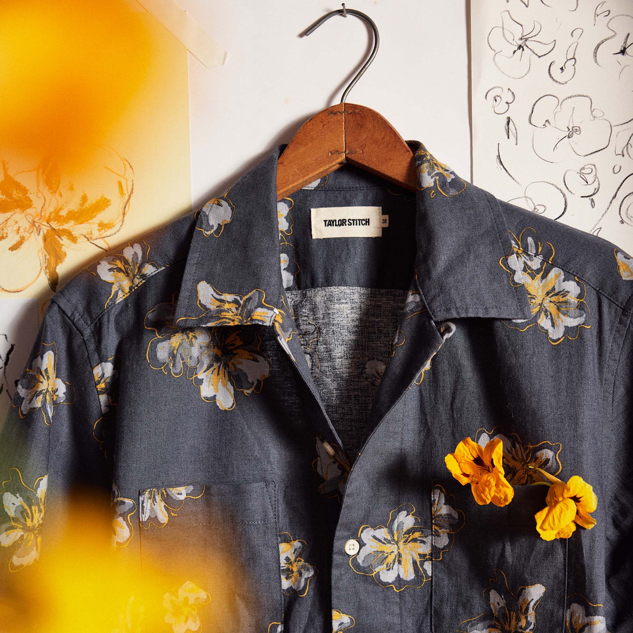 editorial image of The Conrad Shirt in Dark Blue Floral on a hanger, Wovens by Taylor Stitch