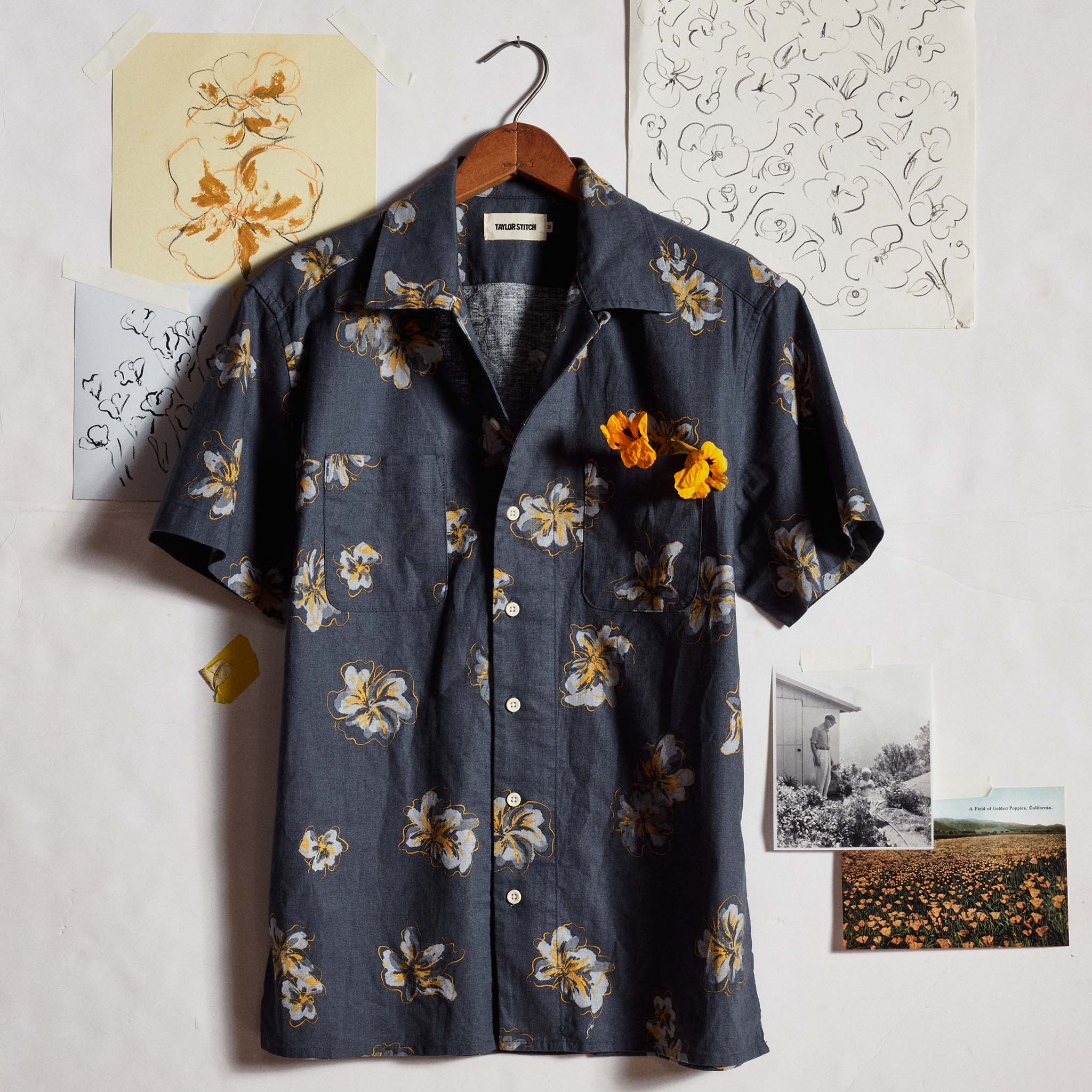 editorial image of The Conrad Shirt in Dark Blue Floral in front of drawings, Wovens by Taylor Stitch