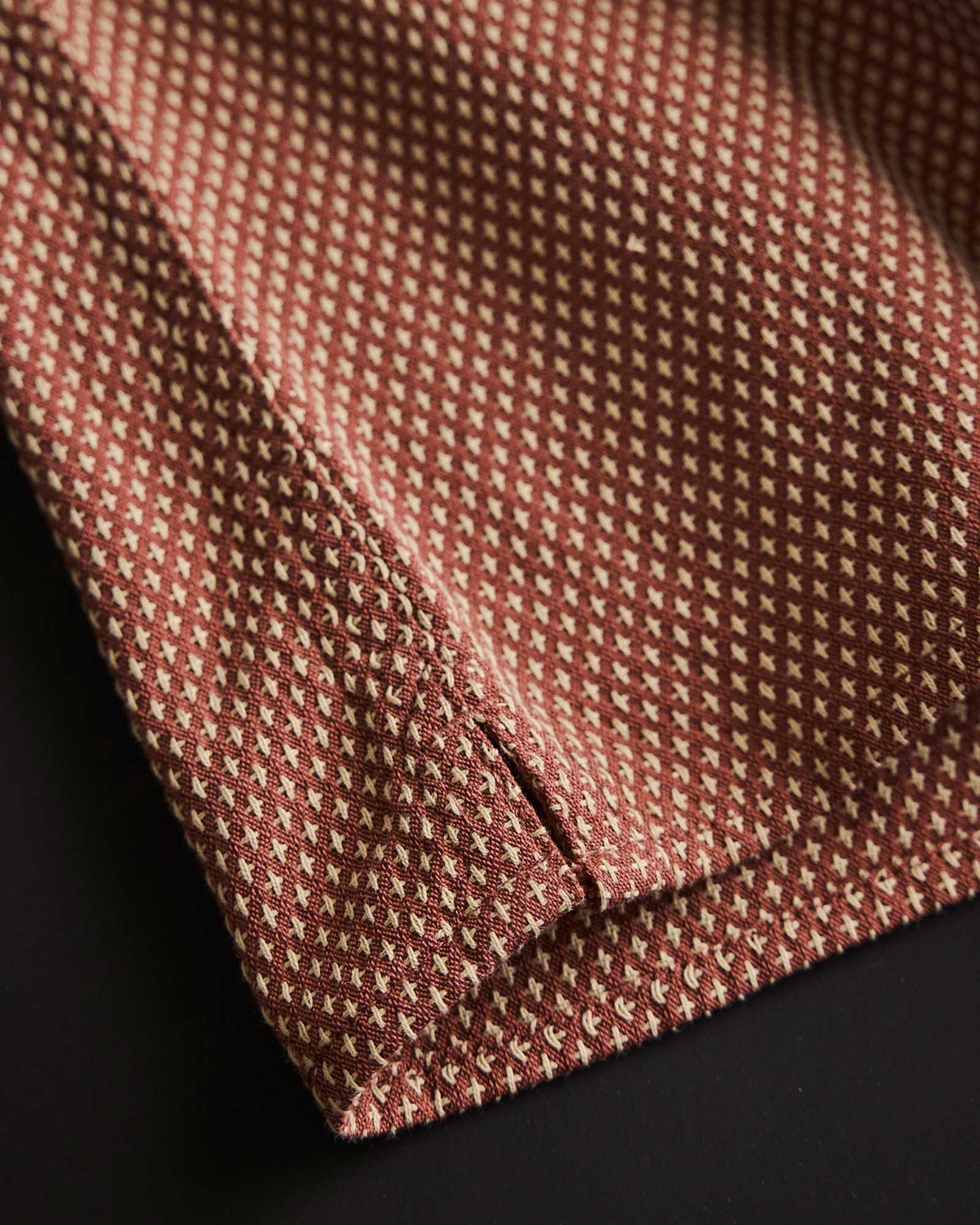 material shot of the hem on The Conrad Shirt in Fired Brick Dobby, Wovens by Taylor Stitch