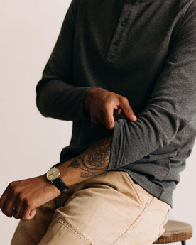 fit model adjusting the sleeves on The Heavy Bag Henley in Heather Grey, Knits by Taylor Stitch
