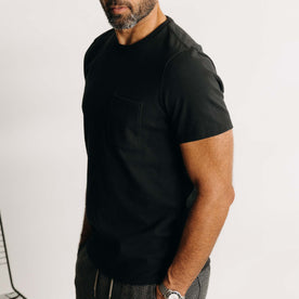 fit model showing off the sleeves on The Heavy Bag Tee in Black