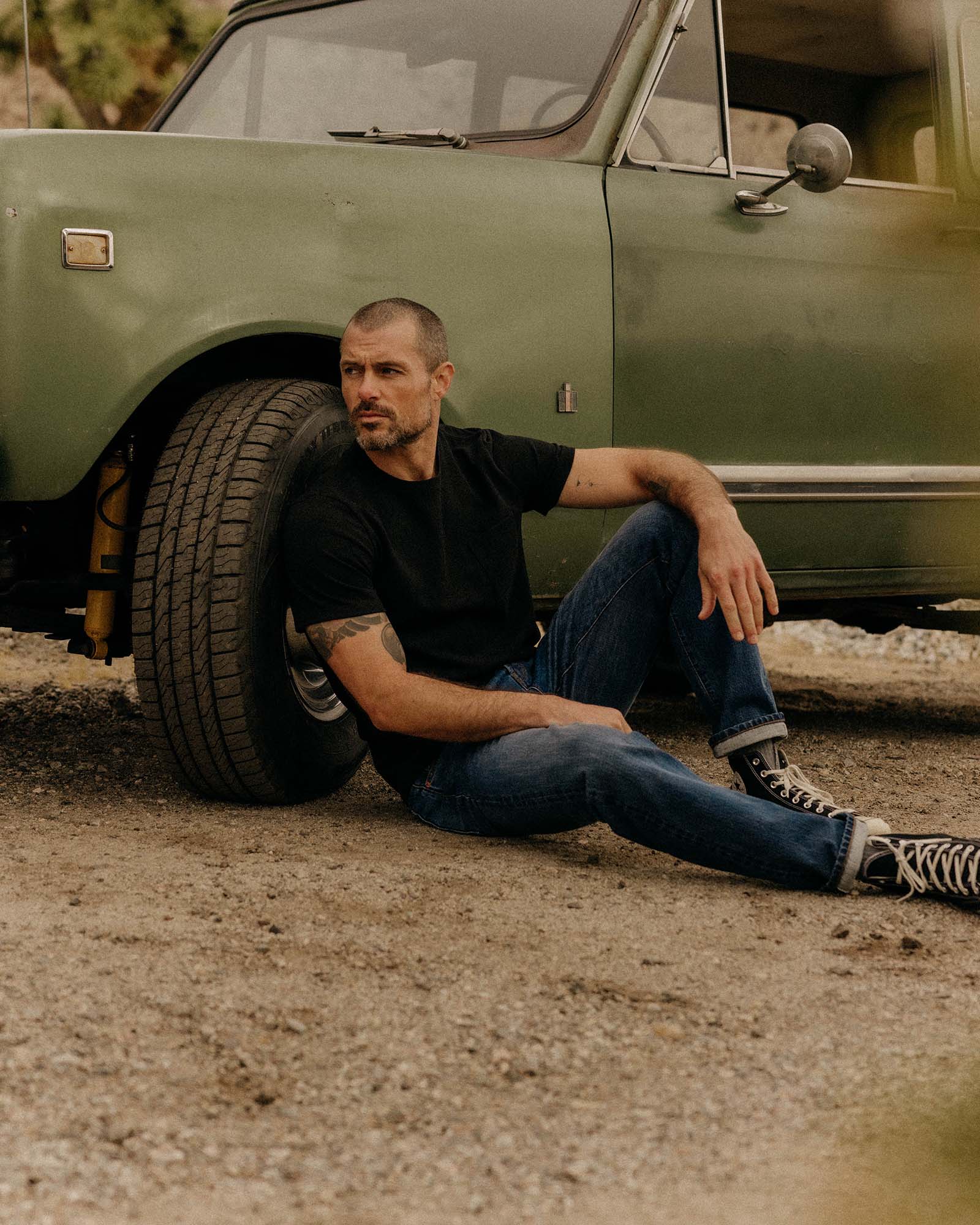 editorial image of The Heavy Bag Tee in Black on a chair, Knits by Taylor Stitch