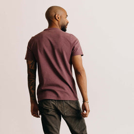 fit model showing off the back of The Heavy Bag Tee in Dried Cherry