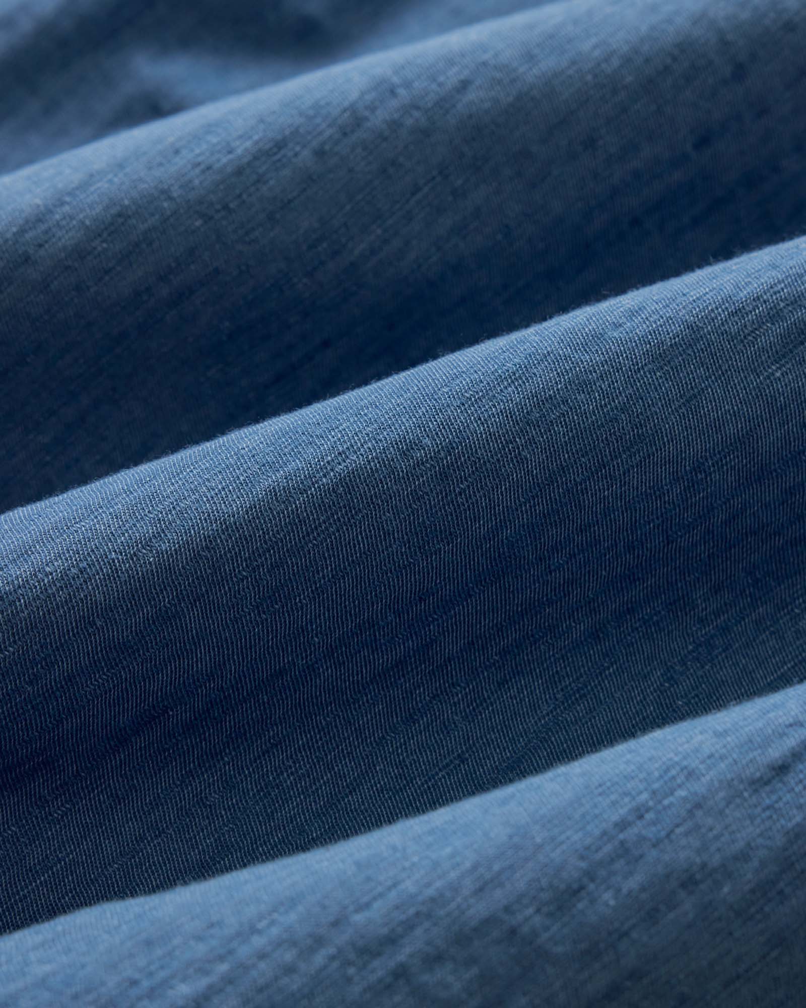 material shot of the buttons on The Short Sleeve California in Washed Indigo Slub, Wovens by Taylor Stitch