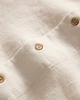 material shot of the buttons on The Short Sleeve Davis Shirt in Natural Palm Embroidery, Wovens by Taylor Stitch