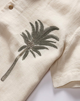 material shot of the palm tree embroidery on The Short Sleeve Davis Shirt in Natural Palm Embroidery, Wovens by Taylor Stitch
