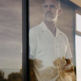 fit model looking through a window wearing The Short Sleeve Hawthorne in Vintage White Embroidered Eyelet