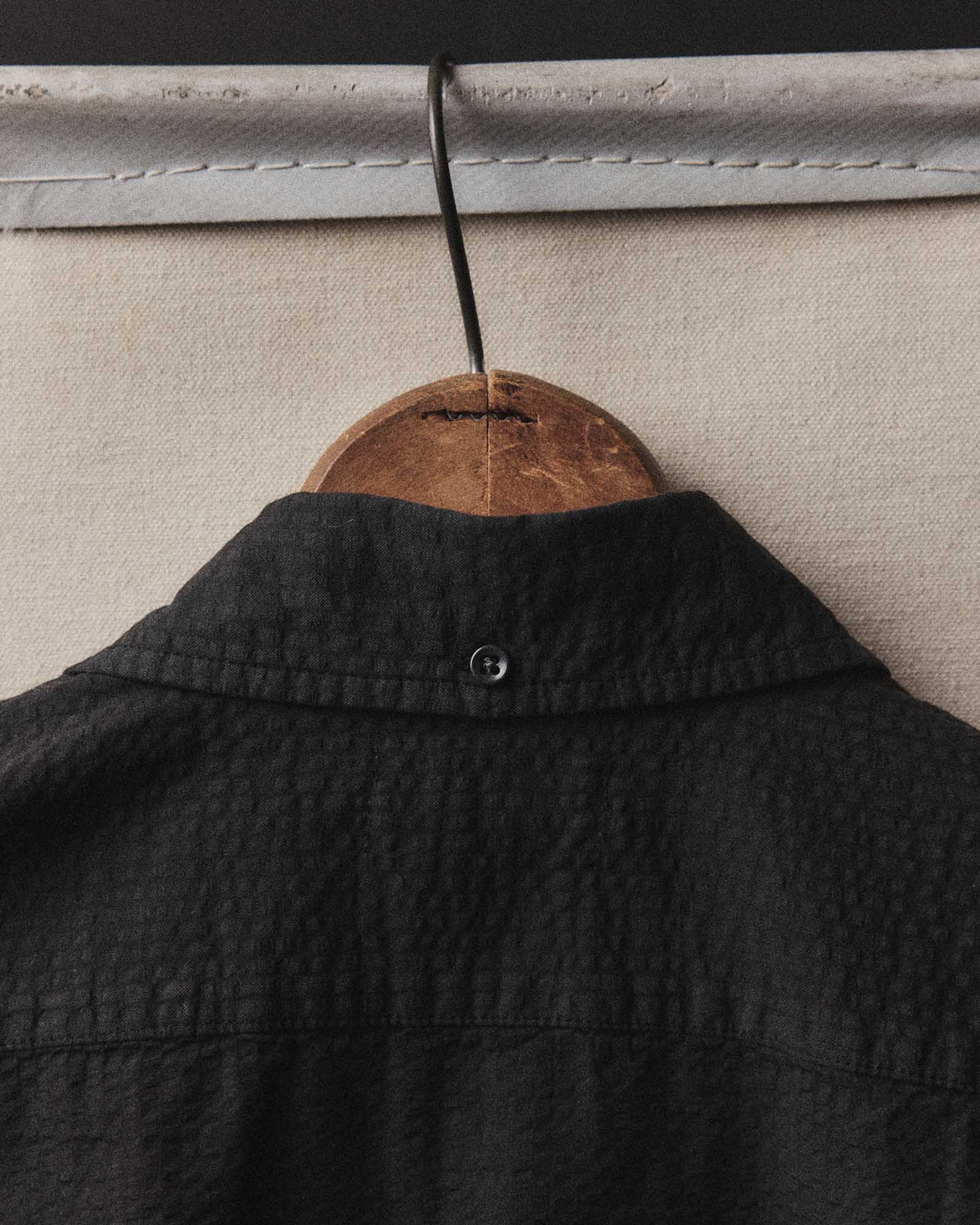 editorial image of the chair on The Short Sleeve Jack in Faded Black Seersucker, Wovens by Taylor Stitch