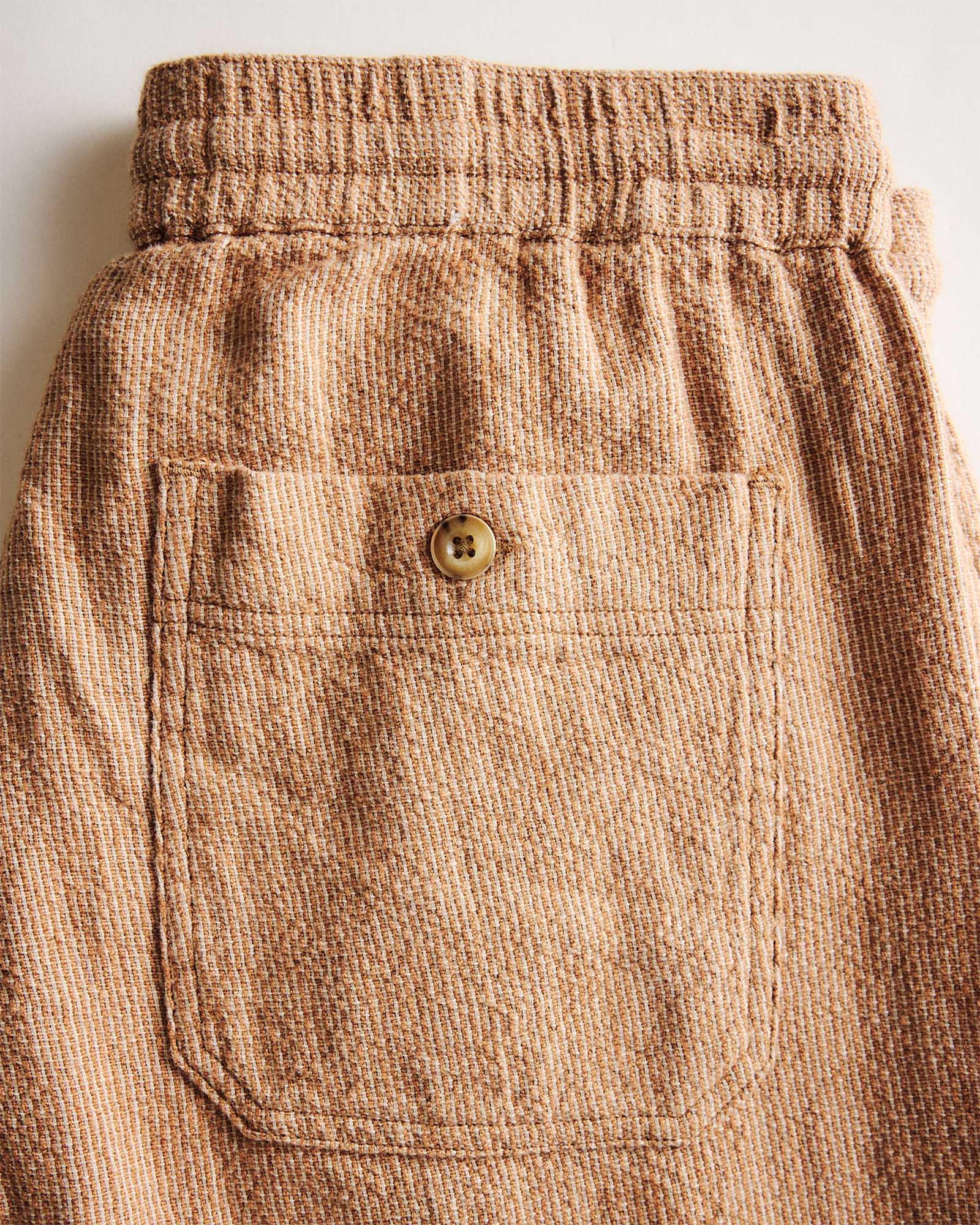 material shot of the back pocket of The Breakwater Pant in Chili Stripe Linen, Bottoms by Taylor Stitch
