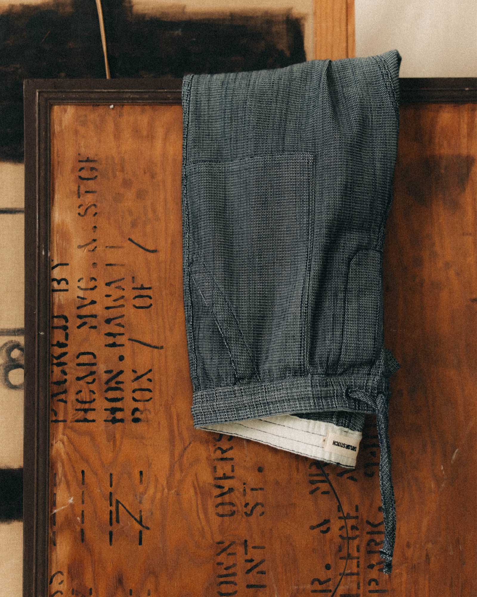 editorial image of The Breakwater Pant in Rinsed Indigo Stripe hanging, Bottoms by Taylor Stitch