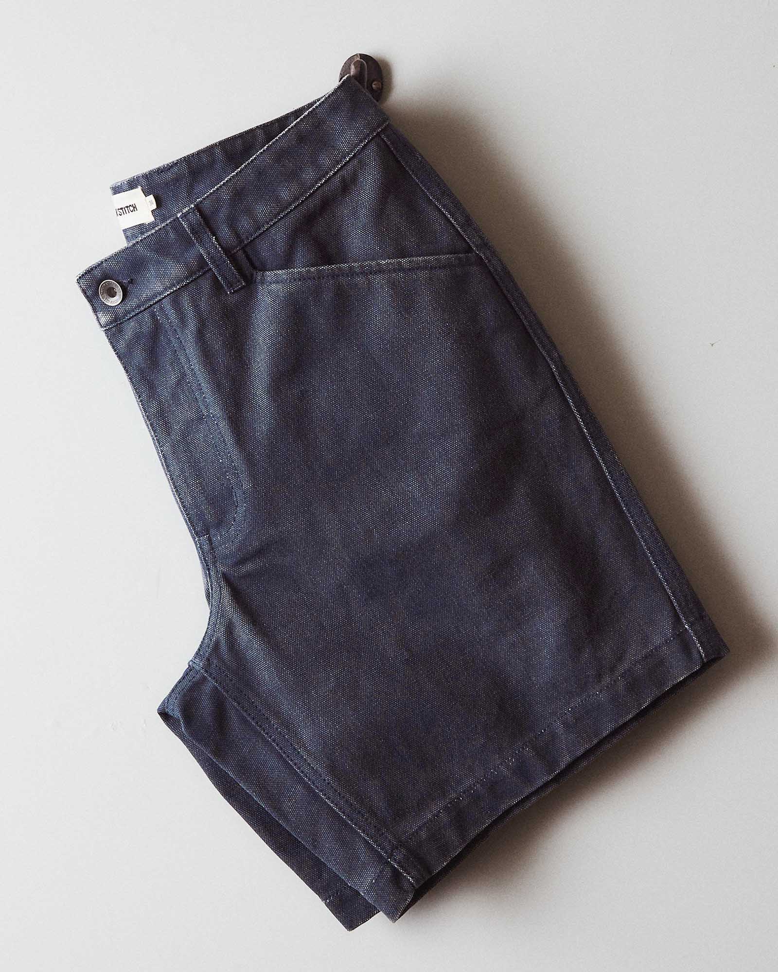 editorial flatlay of The Camp Short in Navy Chipped Canvas folded, Bottoms by Taylor Stitch