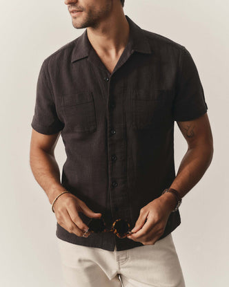 fit model posing in The Conrad Shirt in Faded Black Linen