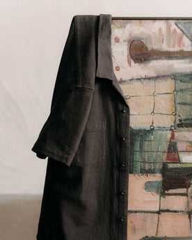 editorial image of The Conrad Shirt in Faded Black Linen hanging on a painting, Wovens by Taylor Stitch