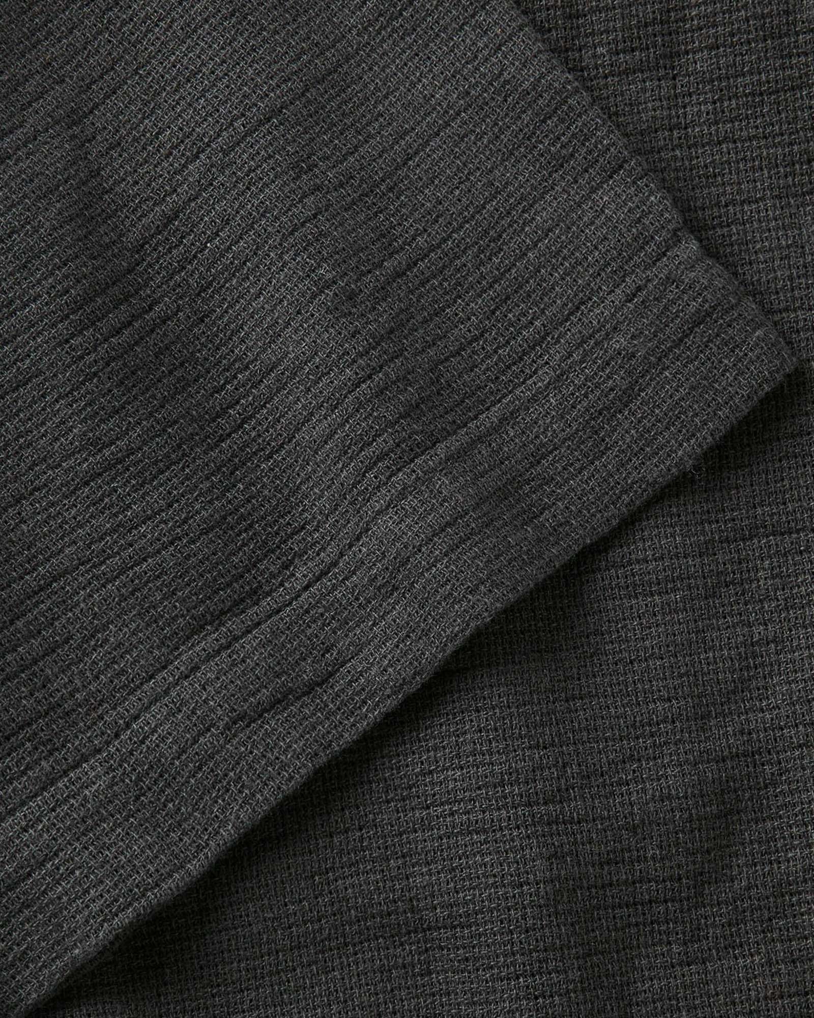 fit model showing off the buttons on The Conrad Shirt in Faded Black Linen, Wovens by Taylor Stitch