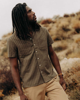 fit model walking wearing The Conrad Shirt in Fatigue Olive Dobby Stripe, Wovens by Taylor Stitch