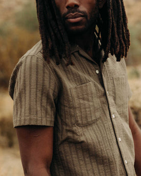 fit model showing off the pockets on The Conrad Shirt in Fatigue Olive Dobby Stripe, Wovens by Taylor Stitch