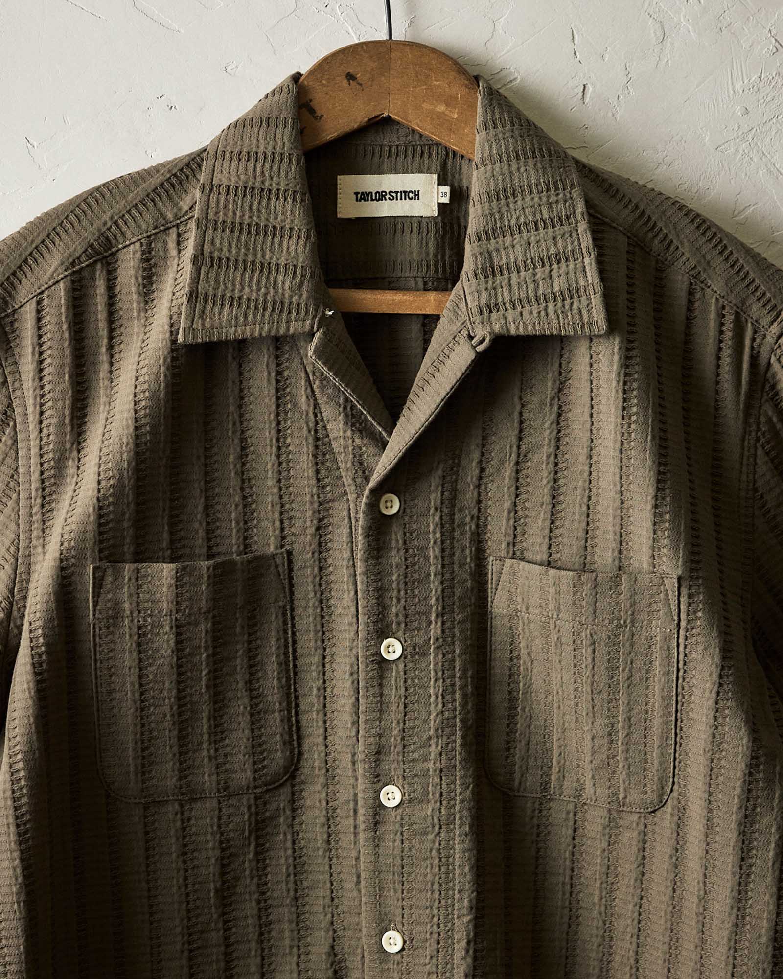 editorial image of The Conrad Shirt in Fatigue Olive Dobby Stripe hanging, Wovens by Taylor Stitch